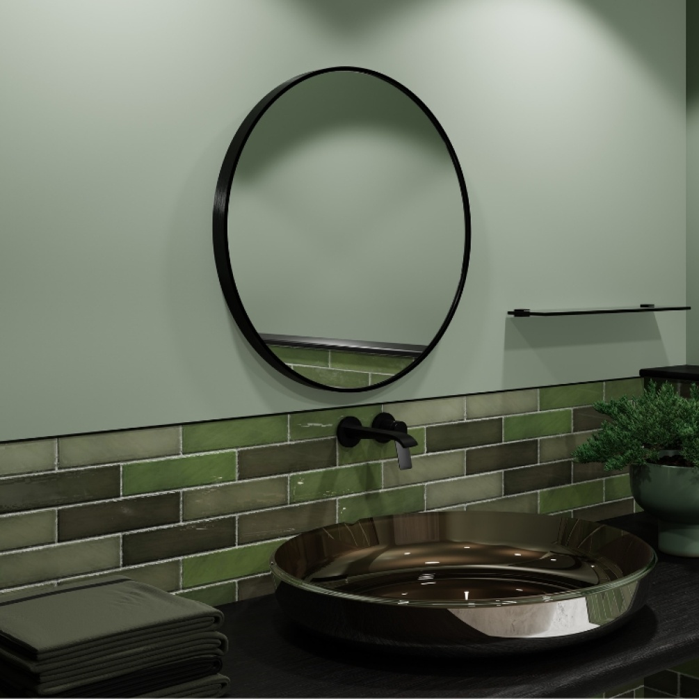 Product Lifestyle image of Origins Living Lomax 600mm x 600mm Black Round Mirror mounted on a wall in-front of a traditional style metal basin. LMX-00D060-BK